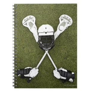 Lacrosse sticks, gloves, balls and sports helmet notebook