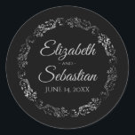 Lacy Silver Filigree Elegant Black Wedding Classic Round Sticker<br><div class="desc">These elegant wedding stickers feature fancy pale gray script text on a black background with a lacy silver faux foil floral border. The text is fully customizable and contains the wedding couple's names and wedding date. Great as favor tags or envelope seals!</div>