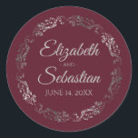 Lacy Silver Filigree Elegant Burgundy Wedding Classic Round Sticker<br><div class="desc">These elegant wedding stickers feature fancy pale grey script text on a burgundy,  maroon or wine red background with a lacy silver faux foil floral border. The text is fully customizable and contains the wedding couple's names and wedding date. Great as favour tags or envelope seals!</div>
