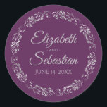 Lacy Silver Filigree Elegant Plum Purple Wedding Classic Round Sticker<br><div class="desc">These elegant wedding stickers feature fancy pale grey script text on a plum purple background with a lacy silver faux foil floral border. The text is fully customizable and contains the wedding couple's names and wedding date. Great as favour tags or envelope seals!</div>