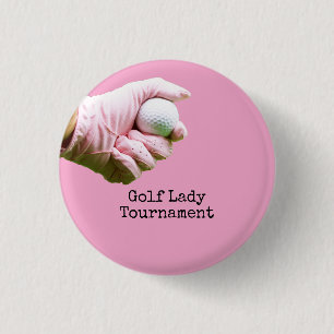 Lady golfer is holding golf ball on pinkbackground 1 inch round button