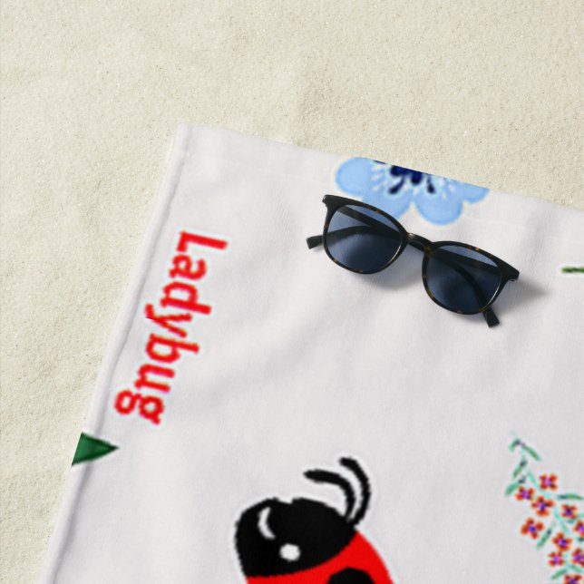 Ladybug pattern on grey beach towel (In Situ)