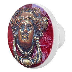 LADY'S HEAD BRASS DOOR KNOCKER (PHOTOG).ON RED CERAMIC KNOB