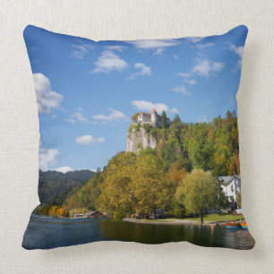 Lake Bled with trees in autumn colours in Slovenia Throw Pillow