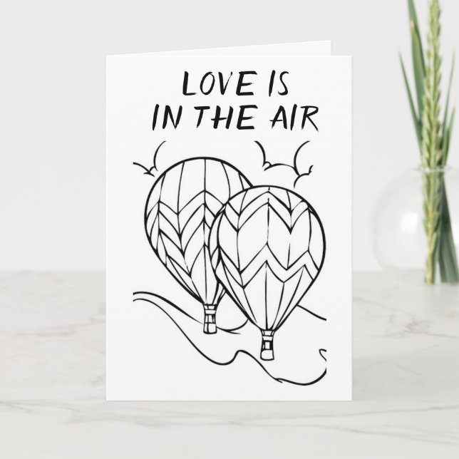 **L'AMOUR** EST EN L'AIR **SUR NOTRE CARTE ANNIVER (Devant)