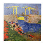 Langlois Bridge at Arles by Vincent van Gogh Tile<br><div class="desc">Langlois Bridge at Arles by Vincent van Gogh is a vintage fine art post impressionism maritime painting featuring peasant women washing clothes in the creek. About the artist: Vincent Willem van Gogh was a Post Impressionist painter whose work was most notable for its rough beauty, emotional honesty, and bold colour....</div>