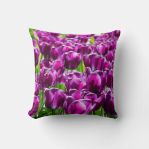 Large field of purple tulips  throw pillow