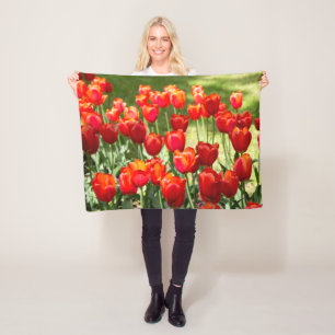Large field of red tulips fleece blanket