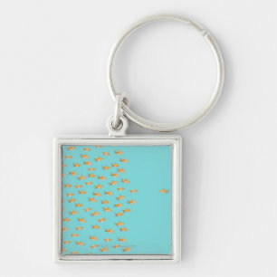 Large group of goldfish facing one lone goldfish keychain