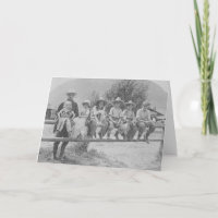 Larry Larom with six children on a fence.