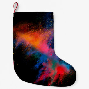 Launched colourful powder on black backgroundcolor small christmas stocking
