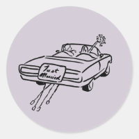 lavender bride and groom in a just married car 