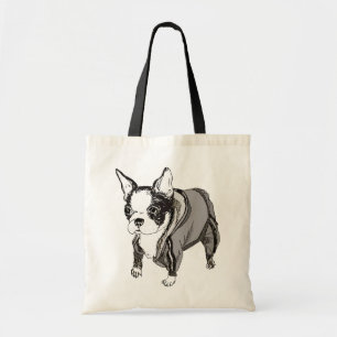 Le chiot de Boston Terrier sue dedans le sac de