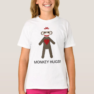 Le singe de chaussette étreint le T-shirt