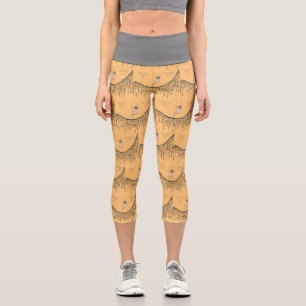 Leggings Capri Capris avec une fille sur la voile en or et noir