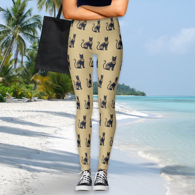 Leggings Couleur de sable à motif de chat noir égyptien (A pair of leggings in sand beige, with Egyptian-inspired black and faux gold cat pattern)