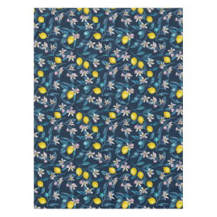 Lemon branches with blossoms and fruit on blue tablecloth