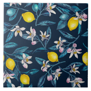 Lemon branches with blossoms and fruit on blue tile
