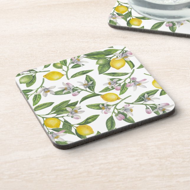 Lemon branches with blossoms and fruit on white coaster (Left Side)