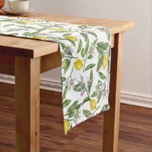 Lemon branches with blossoms and fruit on white short table runner