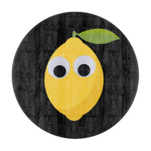 Lemon, sweet fruit with googly eyes cutting board