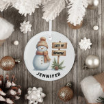 Let it Snow Cozy Winter Snowman Custom Name Glass Ornament<br><div class="desc">Embrace the magic of winter with our delightful Snowman Christmas Ornament! Featuring an adorable snowman dressed in a cozy hat and scarf, this enchanting piece is sure to bring a smile to your face. Next to him stands a charming sign that says “Let it Snow, ” Surrounded by lush evergreen...</div>