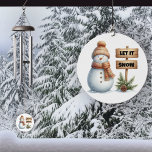 Let it Snow Cozy Winter Snowman Wind Chime<br><div class="desc">Embrace the magic of winter with our delightful Snowman Wind Chime! Featuring an adorable snowman dressed in a cozy hat and scarf, this enchanting piece is sure to bring a smile to your face. Next to him stands a charming sign that says “Let it Snow, ” Surrounded by lush evergreen...</div>