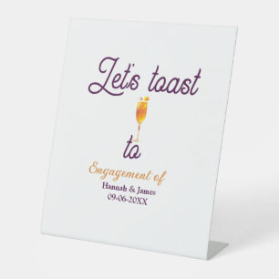 Let's toast to engagement party name date glass pedestal sign