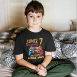 Level 7 Unlocked - Fun Birthday 7 Gamer  T-Shirt<br><div class="desc">Celebrate your child's 7th birthday with this Gamer-themed design for kids' birthdays! With the phrase "LEVEL 7 UNLOCKED AWESOME SINCE CUSTOMIZABLE YEAR" in modern green and white typography and a gamer controller in the background. The design is personalized with your child's year of birth, ideal for giving as a gift...</div>