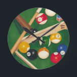 Lifelike Billiards Table with Balls and Chalk Round Clock<br><div class="desc">Rack 'em up with this spectacular painting of a billiards table by Jennifer Goldberger. The balls look new, the felt looks immaculate, and the chalk has already been applied to the cue sticks. Hang this in your home, or gift it to a friend or loved one who enjoys a game...</div>