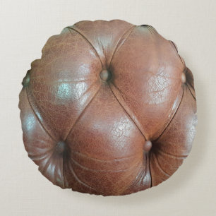 Light on brown leather sofa surface, textureabstra round pillow