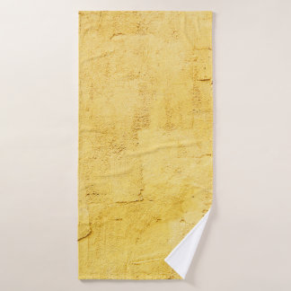 light yellow abstract textured plaster on the wall bath towel