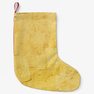 light yellow abstract textured plaster on the wall small christmas stocking