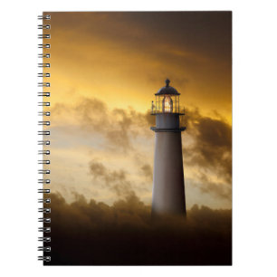 Lighthouse Glowing under Dramatic Sky Notebook