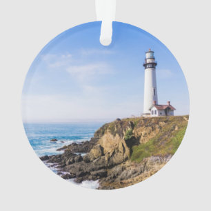 Lighthouse on hill blue sky white house ocean ornament