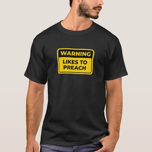 LIKES TO PREACH - Funny Warning Sign Word Joke Hum T-Shirt (Front)