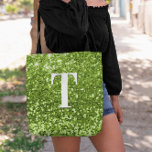 Lime Green Faux Glitter Bokeh Sparkly Monogram Tote Bag<br><div class="desc">A modern bold single letter monogram in white with a black drop shadow. The font size, colour and style are customizable. The background is a lime green glitter with sparkly spots or bokeh. Move or delete the tiny faux sparkle graphic images. A custom gift for a bridesmaid or other member...</div>