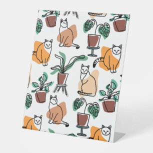 Line art drawing cats and flowers pedestal sign
