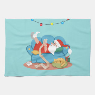 Linge De Cuisine Père Noël sur le canapé en pyjama
