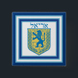 Lion of Judah Emblem Ariel Hebrew 2 Inch Square Button<br><div class="desc">Square button with an image of a blue and yellow Lion of Judah emblem on white with light blue and dark blue borders and “Ariel” in Hebrew in blue letters above it. See matching square charm, large square premium metal keychain, square double-sided acrylic keychain, round necklace and wrist watch. See...</div>