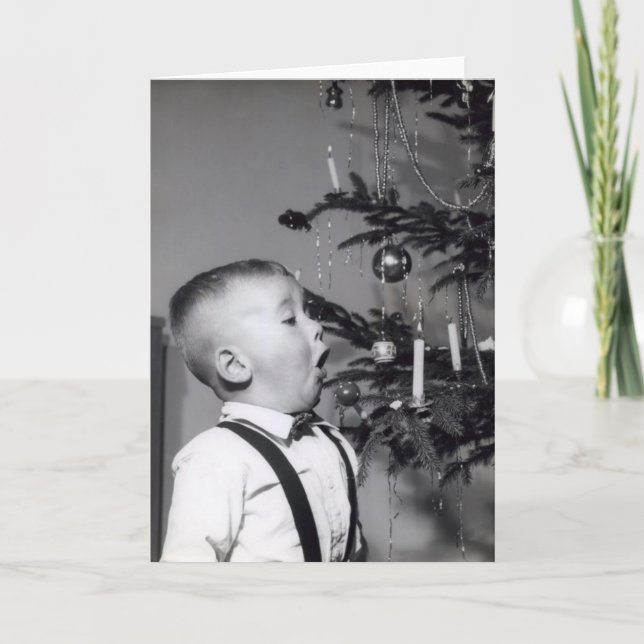 Little boy blows out candle on Christmas tree Holiday Card (Front)