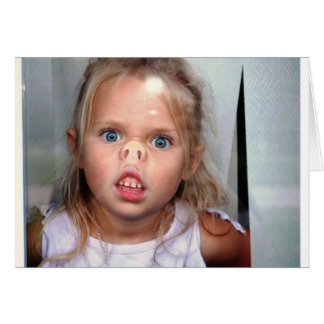 Little girl pressing her nose against a window