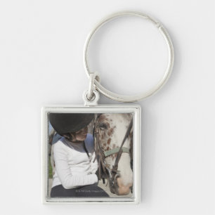 Little girl with her horse keychain