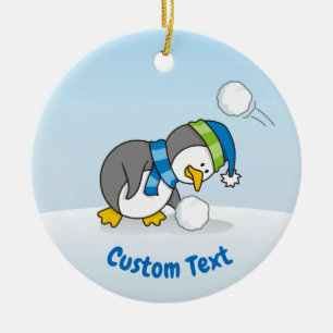 Little penguin getting a snow ball ceramic ornament