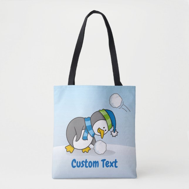 Little penguin getting a snow ball tote bag (Front)