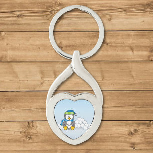 Little penguin sitting with snowballs keychain