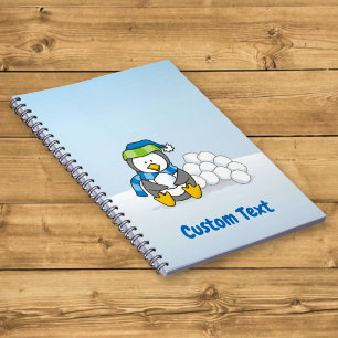 Little penguin sitting with snowballs notebook