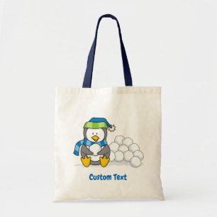 Little penguin sitting with snowballs tote bag