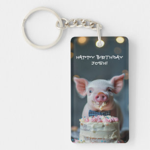 Little piglet munching on a birthday cake keychain