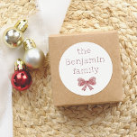 Little Red Bow | Custom Family Name Christmas Classic Round Sticker<br><div class="desc">Add a festive touch to your holiday gifts and cards with this charming round sticker! Featuring your family name in simple, modern typography and a cute watercolor red bow beneath it, this sticker is perfect for sealing envelopes, decorating gift boxes, or adding a special touch to party favours. Check out...</div>
